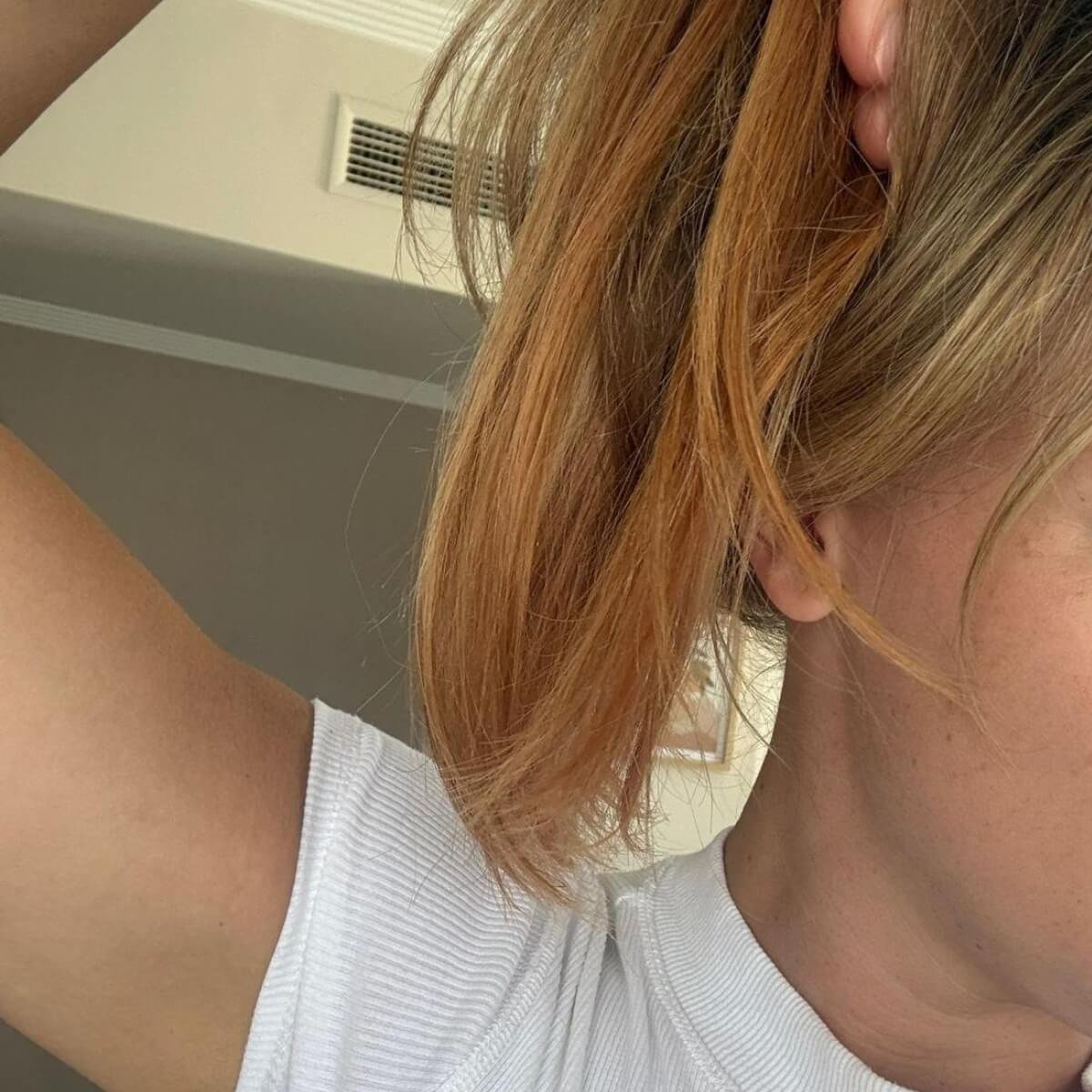 Hair extensions that have turned pink and orange from sun cream and hard water