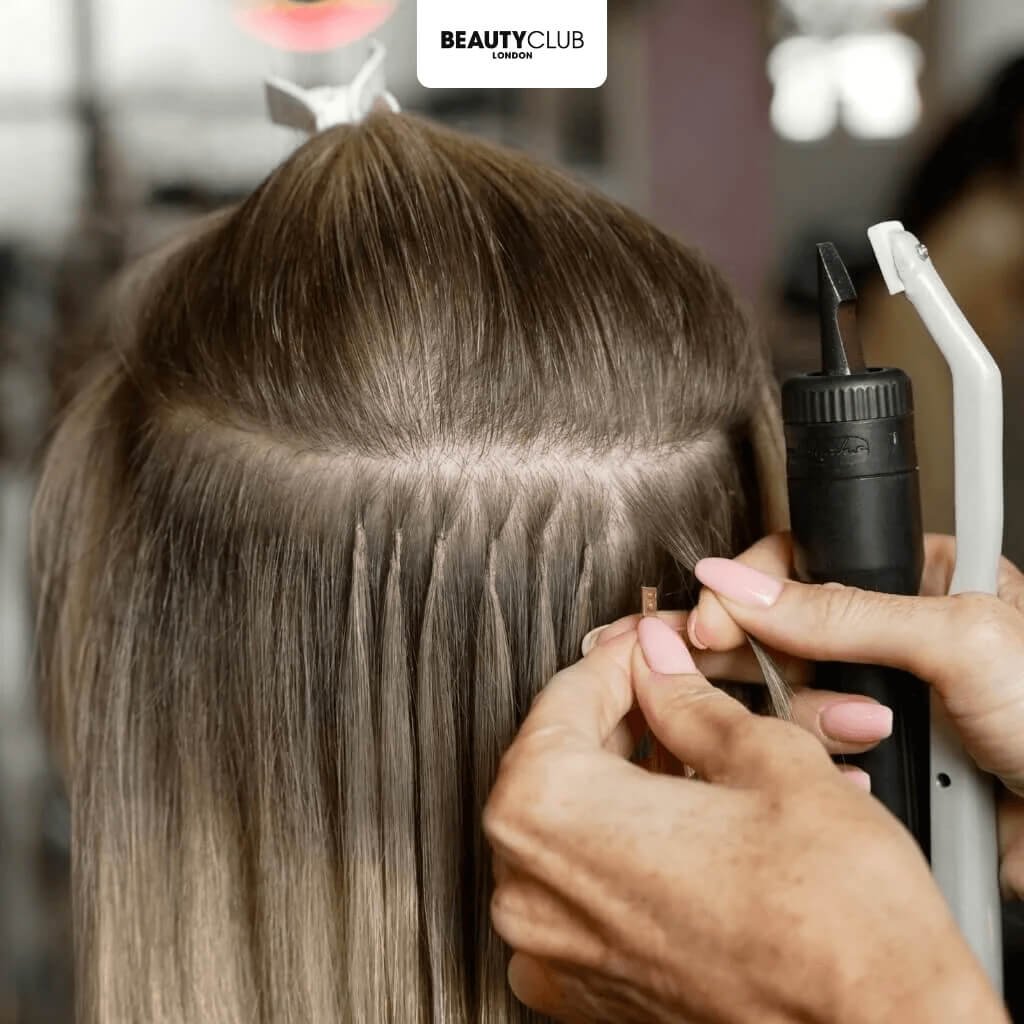 hair extensions being fitted to hair by an expert