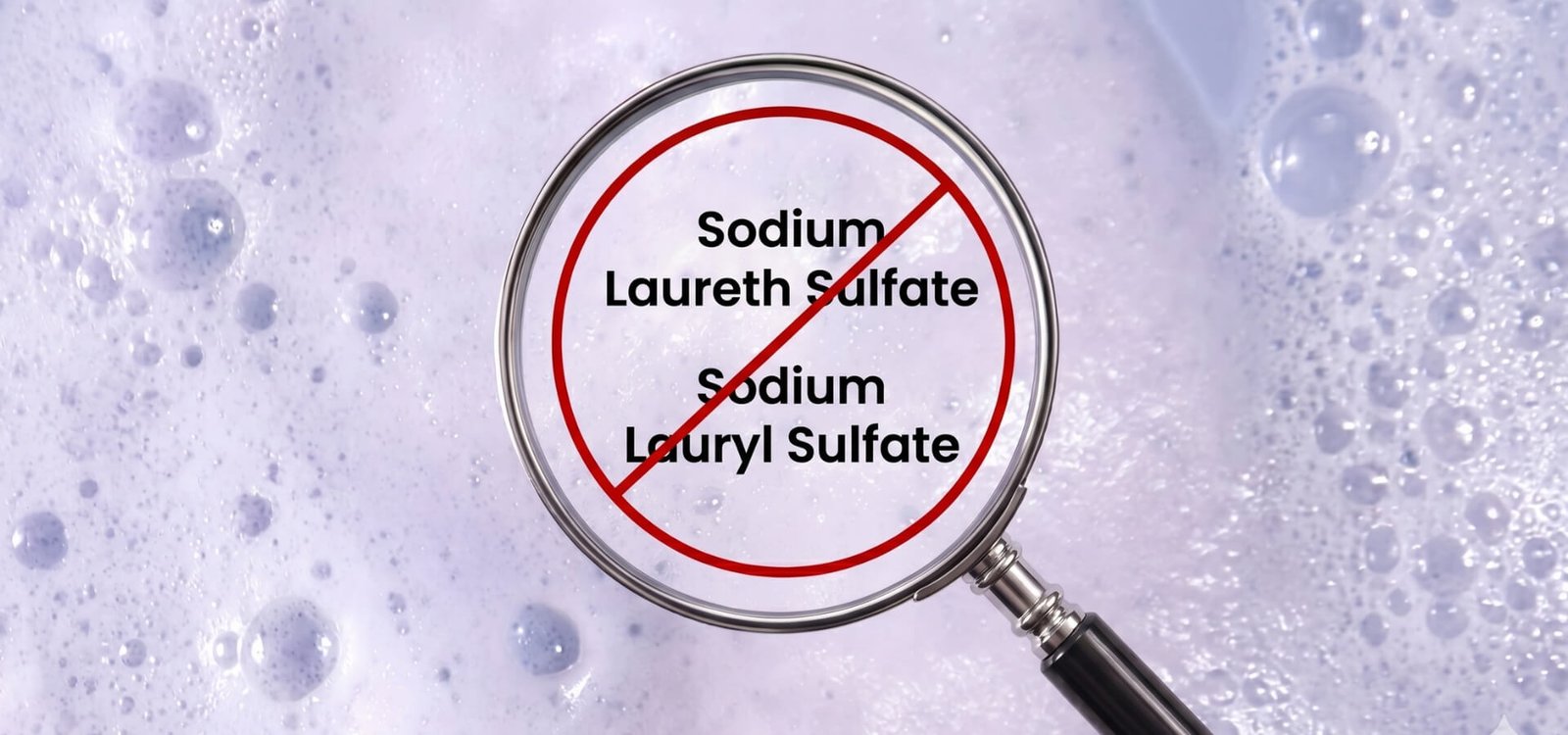 Magnifying glass over shampoo lather marking sodium laureth sulphate and sodium lauryl sulphate as ingredients to avoid in shampoo for hair extensions